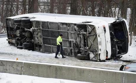 A Connecticut State Police officer investigated an overturned casino-bound tour bus on I-95 North in Madison, Conn.
