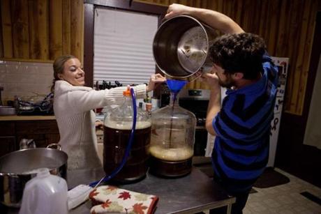 Michelle Belliveau helps Jeff Hoogenboom with a batch of homebrew.
