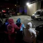 Family members of inmates stood outside the Topo Chico Prison as an ambulance left the compound in Monterrey, Mexico, Thursday. At least 52 inmates were killed when a fight broke out between rival factions, an official said.