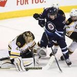WINNIPEG, MB - FEBRUARY 11: Andrew Copp #9 of the Winnipeg Jets and Tuuka Rask #40 of the Boston Bruins battle for the puck in first period action in an NHL game at the MTS Centre on February 11, 2016 in Winnipeg, Manitoba, Canada. (Photo by Marianne Helm/Getty Images)