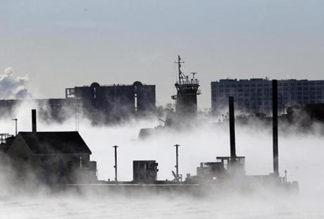 East Boston, MA - 2/14/2016 - A ship makes its way into Boston Harbor as sea smoke rises off of the water seen from East Boston, MA February 14, 2016. Jessica Rinaldi/Globe Staff Topic: 15cold Reporter: 
