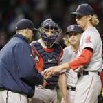 Boston Red Sox starting pitcher Henry Owens, right, hands the ball to manager John Farrell in the fifth inning of a baseball game against the Cleveland Indians, Friday, Oct. 2, 2015, in Cleveland. (AP Photo/Tony Dejak)