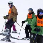Marine veteran Tim Fallon (left) was assisted in his return to the ski slopes by guides Pierre Swick and Tim Robson, who told him when and where to turn.