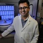 Amrit Chaudhur, with a peptide synthesizer, often juggles a disparate set of roles as CEO at Mass Innovation Labs, an incubator of tech firms in Kendall Square.