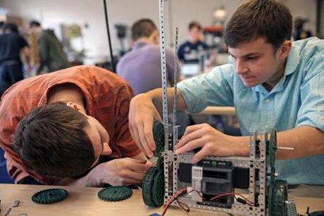 Students Brad Bedarian (left) and Ross Carboni worked on a robotics project at the modern Franklin High School. The new Angier Elementary School in Newton (below) has wireless technology in every classroom. 

