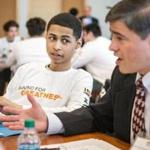 Victor Amaker (left) of Framingham High School listened to mentor Lino Covarrubias Friday during the launch of the 100 Males to College program, which was held at Framingham State University. 