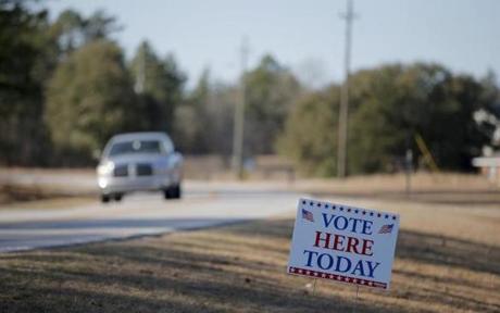 A vehicle drove down the road past a polling place during the US Democratic presidential primary election in Kershaw, South Carolina on Saturday. 
