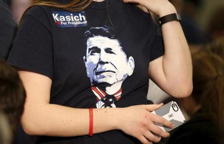 A girl wore a t-shirt with an image of Ronald Reagan, and a John Kasich sticker, in Virginia.
