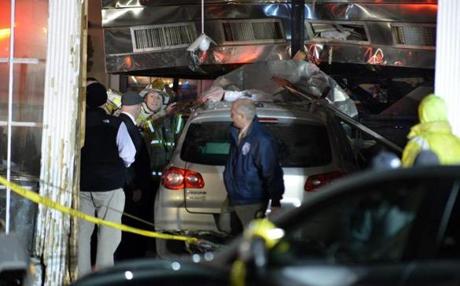 Emergency responders prepared to remove the Volkswagen that crashed into a Newton restaurant Tuesday. 
