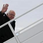 Senator Bernie Sanders waved as he boarded a plane in Vermont Wednesday to return to the campaign trail after Super Tuesday.