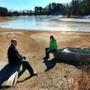 Mark Gilmore and Kyle Pribish sat on what used to be the bottom of Kingsbury Pond in Norfolk, where the water is vanishing.