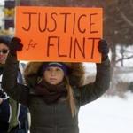 Demonstrators protested the Flint, Mich., contaminated water crisis outside of the venue where the Democratic US presidential candidates' debate was being held Sunday.