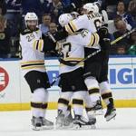Mar 8, 2016; Tampa, FL, USA; Boston Bruins left wing Brad Marchand (63) is congratulated as he scored the game winning goal against the Tampa Bay Lightning during overtime at Amalie Arena. Mandatory Credit: Kim Klement-USA TODAY Sports