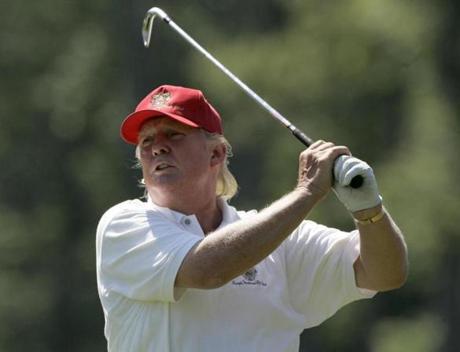 Donald Trump watches his fairway shot on the second hole during the Pro-Am round of the Deutsche Bank Championship golf tournament, in Norton, Mass., Thursday Aug. 30, 2007.(AP Photo/Charles Krupa)
