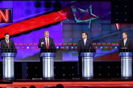 Republican presidential candidates Donald Trump, speaks as Sen. Ted Cruz, R-Texas, Ohio Gov. John Kasich, right, and Republican presidential candidate, Sen. Marco Rubio, R-Fla., left, listen, during the Republican presidential debate sponsored by CNN, Salem Media Group and the Washington Times at the University of Miami, Thursday, March 10, 2016, in Coral Gables, Fla. (AP Photo/)

