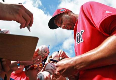 02/20/16: Fort Myers, FL: New Red Sox ace pitcher David Price was in high demand as he signed many autographs for fans following today's workout. Today was the second official day of Spring Training for Red Sox pitchers and catchers at Jet Blue South.(Globe Staff Photo/Jim Davis) section:sports topic:spring training
