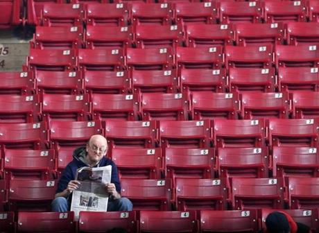 A fan read a newspaper just before the BC-Virginia Tech basketball game at Conte Forum last month. The BC men?s basketball team suffered a fifth consecutive losing season, the program?s longest slump since World War II.
