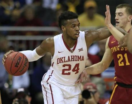 Oklahoma guard Buddy Hield (24) works against Iowa State guard Matt Thomas (21) during the first half of an NCAA college basketball game in the quarterfinals of the Big 12 Conference men's tournament in Kansas City, Mo., Thursday, March 10, 2016. (AP Photo/Orlin Wagner)

