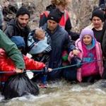 Migrants tried to cross a river after leaving the Idomeni refugee camp in Idomeni, Greece. 