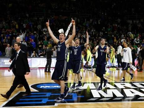 Mar 17, 2016; Providence, RI, USA; Yale Bulldogs forward Sam Downey (44), forward Blake Reynolds (32), and guard Anthony Dallier (1) celebrate their win over Baylor during a first round game during the 2016 NCAA Tournament at Dunkin Donuts Center. Mandatory Credit: Mark L. Baer-USA TODAY Sports
