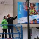 Boston- 03/18/2016- Mayor Marty Walsh joined defending Women's Boston Marathon champion Caroline Rotich and Bill Rodgers to reveal the 2016 Boston Marathon Banners on Boylston Street at the finish line. Rotich and Rodgres on a lift with the new banner.Boston Globe staff photo by John Tlumacki (metro)