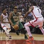 Boston Celtics' Marcus Smart, center, drives through Toronto Raptors' Kyle Lowry, left, and Jason Thompson during first-half NBA basketball game action in Toronto, Friday, March 18, 2016. (Chris Young/The Canadian Press via AP) MANDATORY CREDIT