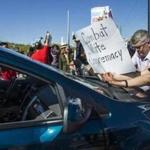Protesters blocked a car on a Fountain Hills, Ariz., street leading to Saturday?s rally Donald Trump.