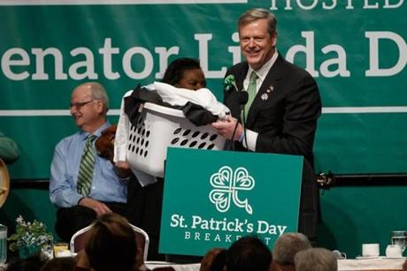  Boston, MA - 3/20/2016 - Massachusetts Governor Charlie Baker carries a jacket of laundry as speaks during the St. Patrick's Day breakfast in Boston, MA, March 20, 2016. (Keith Bedford/Globe Staff) 
