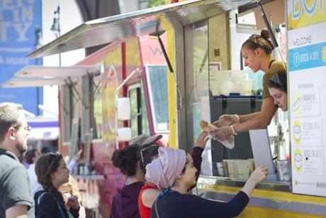 Catherine Aust,  who worked at the Bon Me food truck, served hungry patrons during lunchtime in 2014. 
