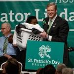 Boston, MA - 3/20/2016 - Massachusetts Governor Charlie Baker carries a jacket of laundry as speaks during the St. Patrick's Day breakfast in Boston, MA, March 20, 2016. (Keith Bedford/Globe Staff) 