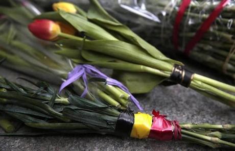 BRUSSEL SLIDER2 Flowers wrapped in ribbons in the colours of the Belgium national flag, are placed outside the Belgium Embassy in Moscow, Russia on Tuesday, March 22, 2016. Authorities in Europe have tightened security at airports, on subways, at the borders and on city streets after deadly attacks Tuesday on the Brussels airport and its subway system. (AP Photo/ Pavel Golovkin)
