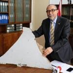 (FILES) This file photo taken on March 3, 2016 shows Joao de Abreu, president of Mozambique's Civil Aviation Institute (IACM), holding a piece of suspected aircraft wreckage found off the east African coast of Mozambique at Mozambique's Civil Aviation Institute (IACM) in Maputo. Two pieces of debris found in Mozambique are 