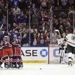 Boston Bruins goalie Tuukka Rask (40) and teammate Zdeno Chara (33) watch as the New York Rangers celebrate a goal by Derek Stepan during the first period of an NHL hockey game Wednesday, March 23, 2016, in New York. (AP Photo/Frank Franklin II)