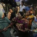 Relatives of the victims of a bomb blast cried outside a hospital in Lahore.