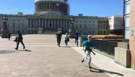 Tourists ran for safety past the entrance to the US Capitol Visitors Center Monday. 

