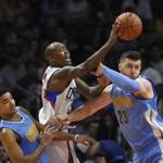 Los Angeles Clippers guard Jamal Crawford, center shoots as Denver Nuggets guard Gary Harris, left, and center Jusuf Nurkic, of Bosnia, defend during the second half of an NBA basketball game, Sunday, March 27, 2016, in Los Angeles. The Clippers won 105-90. (AP Photo/Mark J. Terrill) 