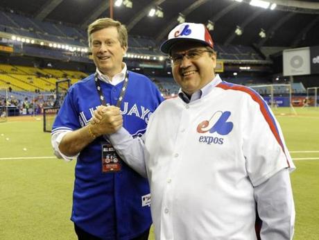 Apr 2, 2016; Montreal, Quebec, CAN; Toronto Mayor John Tory and Montreal Mayor Denis Coderre shake hands before the game between the Boston Red Sox and the Toronto Blue Jays at Olympic Stadium. Mandatory Credit: Eric Bolte-USA TODAY Sports
