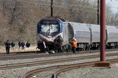 Emergency personnel examine the scene after an Amtrak passenger train struck a backhoe, killing two people, in Chester, Pennsylvania, April 3, 2016. The southbound Palmetto train running from New York to Savannah, Georgia, had about 341 passengers and seven crew members aboard when it struck the backhoe. REUTERS/Dominick Reuter TPX IMAGES OF THE DAY 
