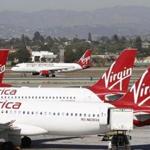 Virgin America jets are seen at Los Angeles airport, California, in this file photo taken November 2, 2013. Alaska Air Group Inc has emerged as the likely winner of an auction for Virgin America Inc , The Wall Street Journal reported on Saturday, citing people familiar with the matter. REUTERS/David McNew/Files