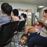 FILE -- Women and children gather at a clinic for a talk about the Zika virus in Carolina, Puerto Rico, Feb. 25, 2016. In an effort to break the two-month deadlock, Obama administration officials announced on April 6 the transfer of $510 million originally intended to protect against Ebola to help combat the Zika virus -- as congressional Republicans had demanded. (Victor J. Blue/The New York Times)