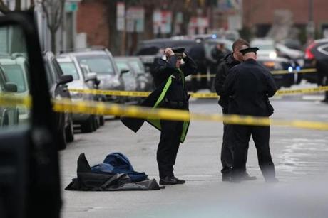 Body armor was piled on a Cambridge street as officials continued their investigation Thursday into what they called an act of workplace violence. 
