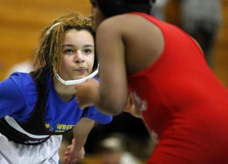 Boston, MA - 2/14/2016 - Boston Youth Wrestling's Kayla Lee, a seventh grader, sized up her opponent during a wrestling meet at Madison Park High School in Boston, MA February 14, 2016. Jessica Rinaldi/Globe Staff Topic: wrestling Reporter: 
