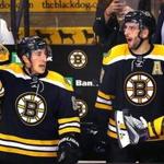 Boston- 04/07/2016- Boston Bruins vs Detroit Red Wings- Bruins Brad Marchand(left) and Patrice Bergeron cheer with seconds left in the game with the score, 5-2 Bruins. Boston Globe staff photo by John Tlumacki (sports)