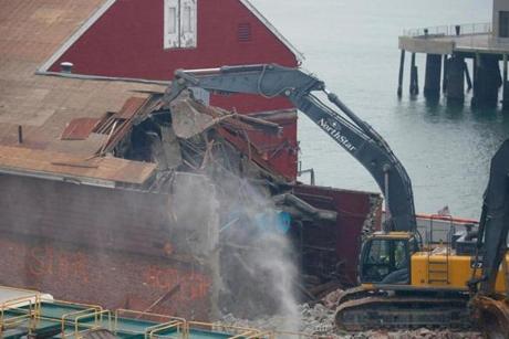 Demolition of the former Anthony?s Pier 4 building began Tuesday morning. 
