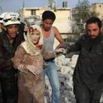 Syrian rescue workers and residents helped an injured woman after a reported air strike by government forces on the rebel-held neighborhood of Haydariya in Aleppo on Sunday.