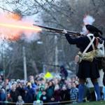 Minutemen fired their weapons Monday morning as part of the reenactment of the 1775 Battle of Lexington.