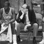 FILE - In this March 10, 1984, file photo, Syracuse coach Jim Boeheim, right, and Syracuse player Dwayne Washington (31) watch as Georgetown University took control in overtime of the Big East Conference championship basketball game at Madison Square Garden in New York. Syracuse coach Jim Boeheim, current and former players, and others associated with the program continue to rally in support of former Orange star Dwayne Pearl Washington, who?s afflicted with brain cancer. (AP Photo/Ray Stubblebine, File)