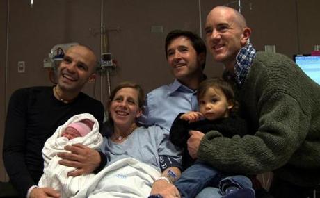 Sandro (left) and Erik (right), holding their daughters Eleonora (left) and Rachel Maria, with surrogate Rachel and her husband, Tony.
