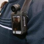 A Frrench police officer wears a body-worn camera.