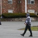 Ahmed al Rubaye met his children as they got off the bus in Saugus on Tuesday. The state had threatened to evict them from their motel for allowing guests inside their rooms.